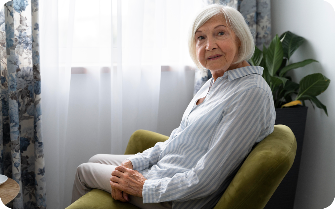 eolderly woman with dementia sitting in a green chair
